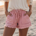 Lightweight and loose-fitting with large pockets, fringed shorts